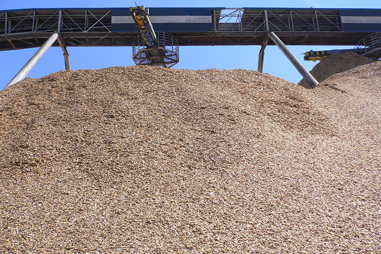 Large hill of wood chips.