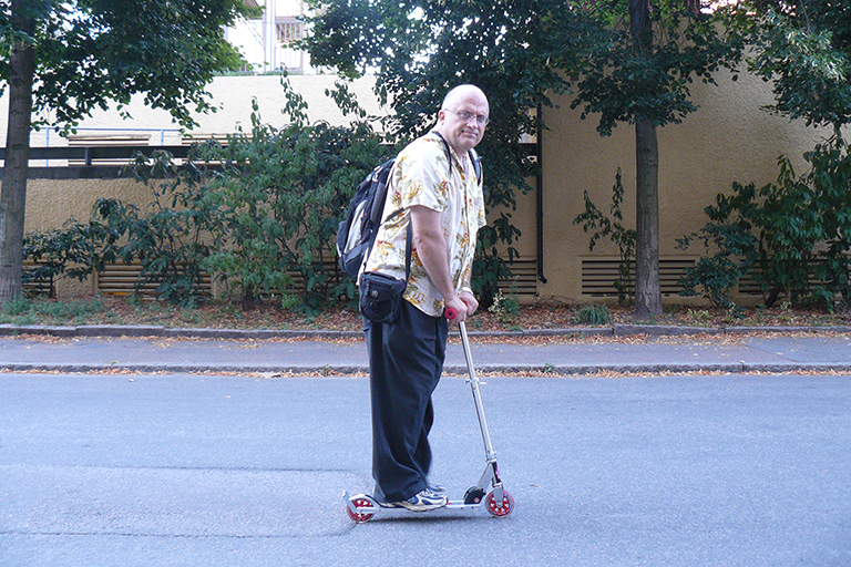 Art Ragauskas rides a nonmotorized scooter.